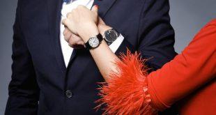 Close-up of couple hands. Well dressed stylish man and woman wearing wristwatches.